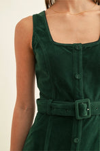 Close-up of Kensley hunter green dress showing square neckline, buttons, and belt