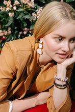 noonday collection drop earrings handcrafted discs outlined in shining gold luster