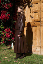 Moon River Chocolate faux-leather A-line midi skirt styled with matching jacket and boots, front view