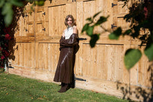Moon River Chocolate faux-leather midi skirt styled outdoors with ivory top and boots