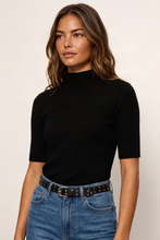 Sanctuary High Neck Ribbed Top in Black, model view styled with blue jeans and a black belt.